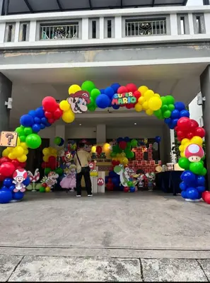 a man standing in front of a bunch of balloons at 30PAX 7BR Villa with Kids Swimming pool, KTV, Pool Table n BBQ near SPICE Arena Penang 9800 SQFT in Bayan Lepas