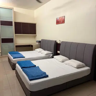 a room with three beds with blue towels on them at 30PAX 7BR Villa with Kids Swimming pool, KTV, Pool Table n BBQ near SPICE Arena Penang 9800 SQFT in Bayan Lepas