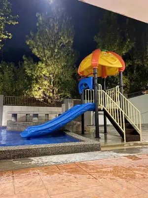 a playground with a slide and an umbrella at 30PAX 7BR Villa with Kids Swimming pool, KTV, Pool Table n BBQ near SPICE Arena Penang 9800 SQFT in Bayan Lepas
