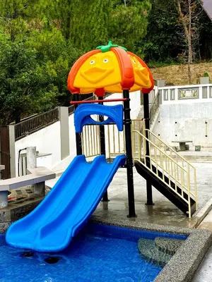 a playground with an umbrella and a blue slide at 40 PAX 9BR Villa with Kids swimming Pool, KTV, BBQ n Pool Tables near SPICE Arena Penang 9800 SQFT in Bayan Lepas