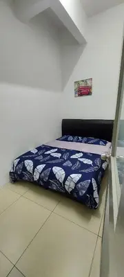 a bed in a room with a blue blanket on the floor at Cameron 3room Golden Hills in Brinchang