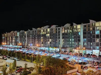 a large building with a parking lot in front of it at Cameron 3room Golden Hills in Brinchang