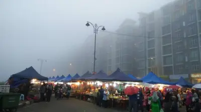 a crowd of people at an outdoor market with blue tents at Cameron 3room Golden Hills in Brinchang