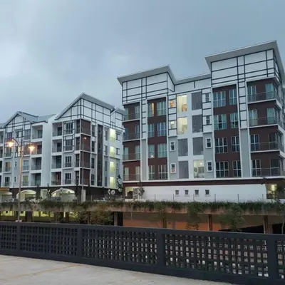 a large building with many windows next to a bridge at Cameron 3room Golden Hills in Brinchang
