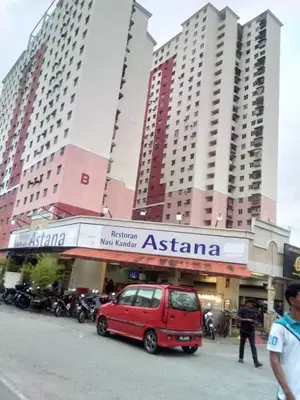 a small red van parked in front of a building at Homestay pangsapuri sutera seberang jaya in Kampong Telok