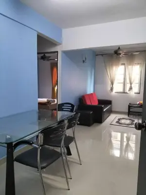 a living room with a glass table and a couch at Homestay pangsapuri sutera seberang jaya in Kampong Telok