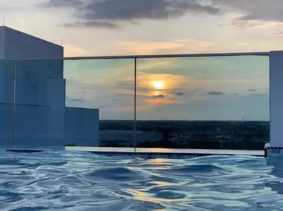 a swimming pool with a view of the sunset at Sri Indar Hotel & Suites in Parit Buntar