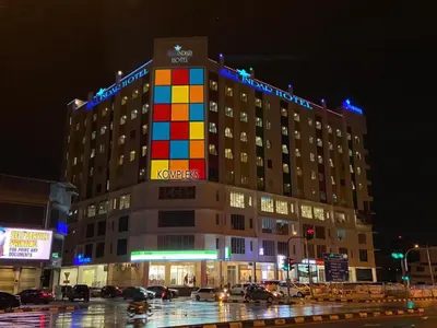 a large building with a rainbow flag on top of it at Sri Indar Hotel & Suites in Parit Buntar