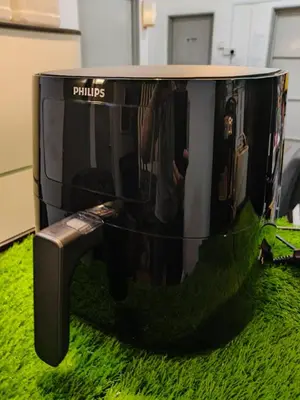 a tv sitting on top of a green carpet at HOMESTAY SYAABAN Kamunting Taiping Batu Kurau Ulu Sepetang in Kamunting