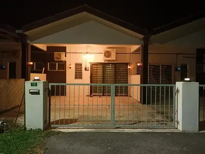 a gate in front of a house at night at HOMESTAY SYAABAN Kamunting Taiping Batu Kurau Ulu Sepetang in Kamunting