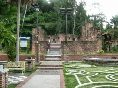 a stone building with a maze on the grass at C 13 Lot 10 Pangkor Leisure Beach Studio in Pangkor