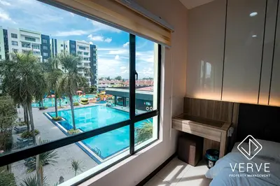 a room with a window with a view of a swimming pool at Ipoh Manhattan Premium Suites by Verve in Ipoh