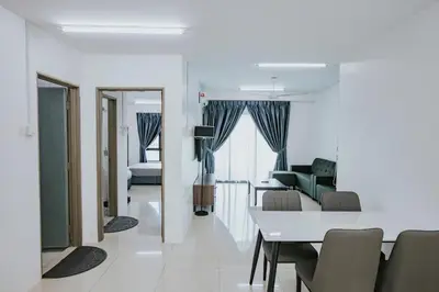 a living room and dining room with a table and chairs at Ipoh Manhattan Premium Suites by Verve in Ipoh