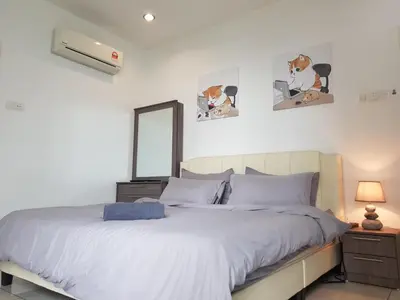 a bedroom with a bed and a mirror at Mansion One Suite by stayCATion Homestay in George Town