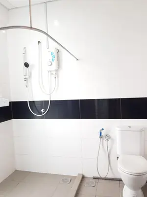 a bathroom with a shower and a toilet at Mansion One Suite by stayCATion Homestay in George Town