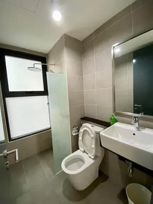 a bathroom with a toilet and a sink at Tropicana 218 Macalister Sea & City View by stayCATion Homestay in George Town
