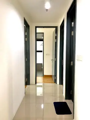 a hallway with black doors and a blue rug on the floor at Tropicana 218 Macalister Sea & City View by stayCATion Homestay in George Town