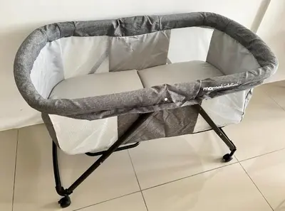 a baby crib with a grey cover on a floor at Tropicana 218 Macalister Sea & City View by stayCATion Homestay in George Town