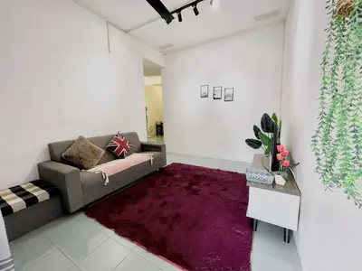 a living room with a couch and a purple rug at Heritage Cozy Entire 3 Bedroom House At Kijang Alma Bukit Mertajam in Bukit Mertajam