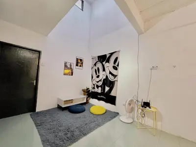 a living room with a yellow frisbee on the floor at Heritage Cozy Entire 3 Bedroom House At Kijang Alma Bukit Mertajam in Bukit Mertajam