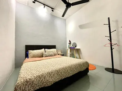 a bedroom with a bed in a white room at Heritage Cozy Entire 3 Bedroom House At Kijang Alma Bukit Mertajam in Bukit Mertajam
