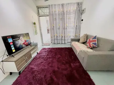 a living room with a couch and a flat screen tv at Heritage Cozy Entire 3 Bedroom House At Kijang Alma Bukit Mertajam in Bukit Mertajam