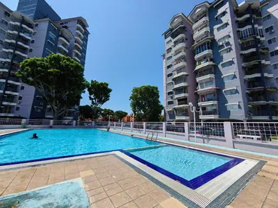 a swimming pool in the middle of two tall buildings at Coastside Homestay in George Town