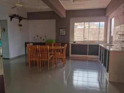 a kitchen and dining room with a table and chairs at Coastside Homestay in George Town