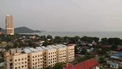 an aerial view of a city with buildings and the ocean at Coastside Homestay in George Town