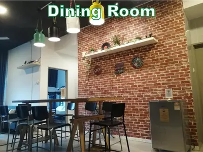 a dining room with a brick wall and tables and chairs at D&C Homestay A Modern Forest Boutique in Brinchang