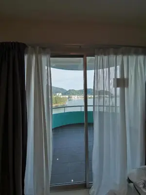 a bedroom with a window with a view of the water at Rustic one bedroom unit for 4pax by Jomy Management in Lumut