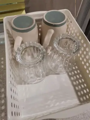 two glass containers sitting in a white basket at Rustic one bedroom unit for 4pax by Jomy Management in Lumut