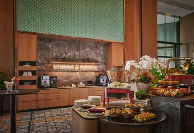 a kitchen with a table with food on it at Amari SPICE Penang in Bayan Lepas