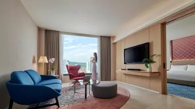 a hotel room with a television and a bed at Amari SPICE Penang in Bayan Lepas