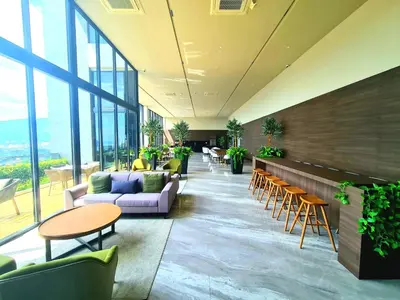a lobby with couches and tables and windows at Beacon Executive Premium Suite in George Town