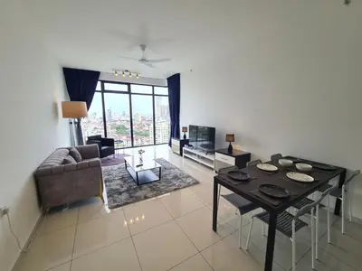 a living room with a table and a couch at Beacon Executive Premium Suite in George Town