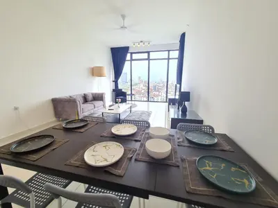 a living room with a table with plates on it at Beacon Executive Premium Suite in George Town