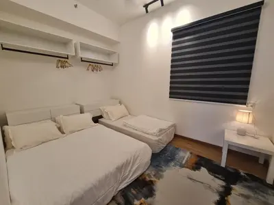 a white bedroom with a bed and a window at Beacon Executive Premium Suite in George Town