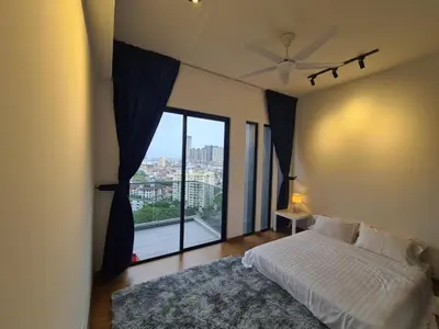 a bedroom with a bed and a large window at Beacon Executive Premium Suite in George Town