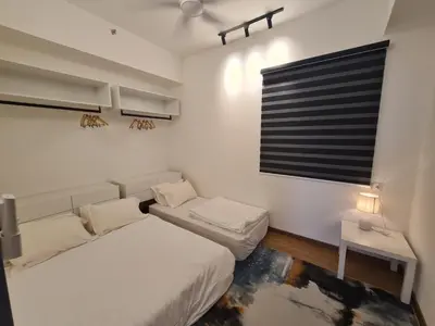 a white bedroom with a bed and a window at Beacon Executive Premium Suite in George Town
