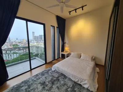 a bedroom with a bed and a large window at Beacon Executive Premium Suite in George Town