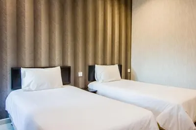 two beds sitting next to each other in a room at Value Inn Homestay in Butterworth