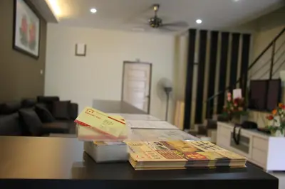two books sitting on a table in a living room at Value Inn Homestay in Butterworth