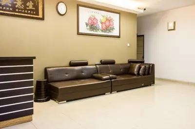 a brown leather couch in a waiting room at Value Inn Homestay in Butterworth