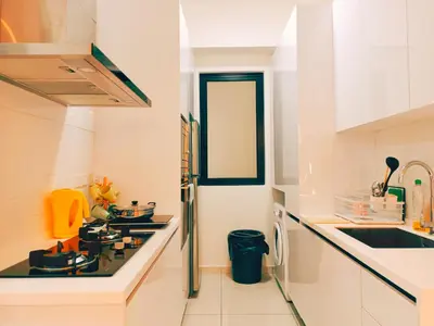 a white kitchen with a stove and a sink at Bali-style 2Bedroom Beacon Georgetown WL in George Town