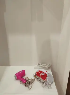 a white table with a cell phone and a corded phone at Bali-style 2Bedroom Beacon Georgetown WL in George Town