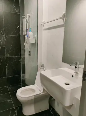 a bathroom with a white toilet and a sink at Bali-style 2Bedroom Beacon Georgetown WL in George Town
