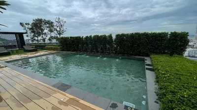 a swimming pool in a yard with a wooden deck at Bali-style 2Bedroom Beacon Georgetown WL in George Town