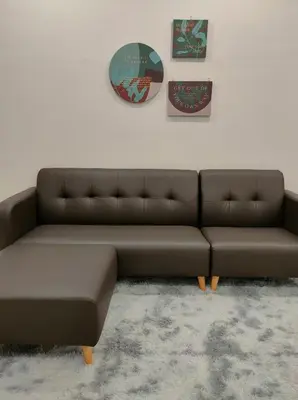 a brown couch sitting in a living room at Bali-style 2Bedroom Beacon Georgetown WL in George Town
