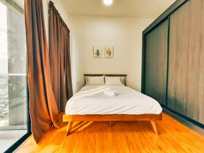 a bedroom with a bed and a large window at Bali-style 2Bedroom Beacon Georgetown WL in George Town